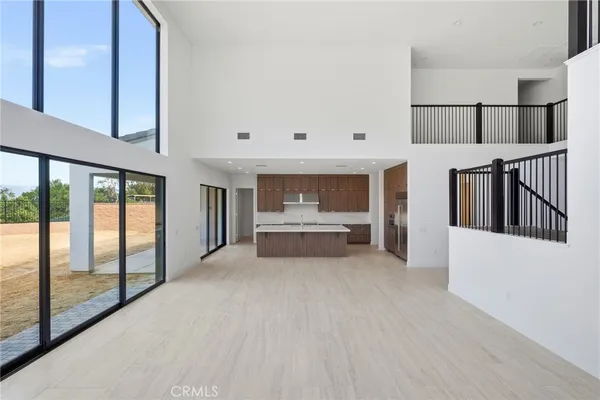 a kitchen with stainless steel appliances granite countertop a sink and a refrigerator