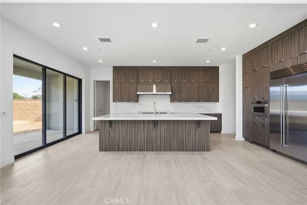 a view of a closet with wooden floor