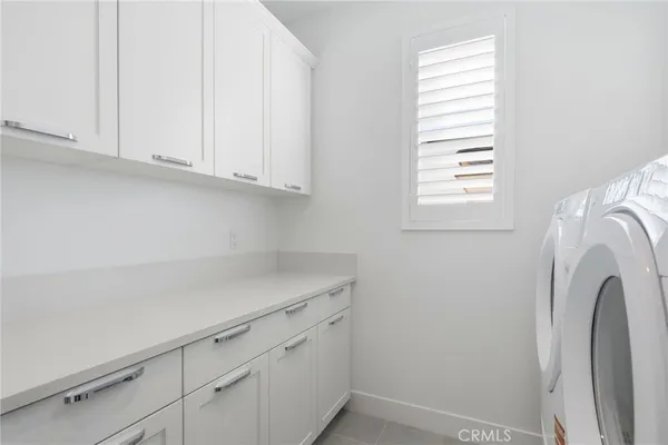 an empty room with a ceiling fan and window