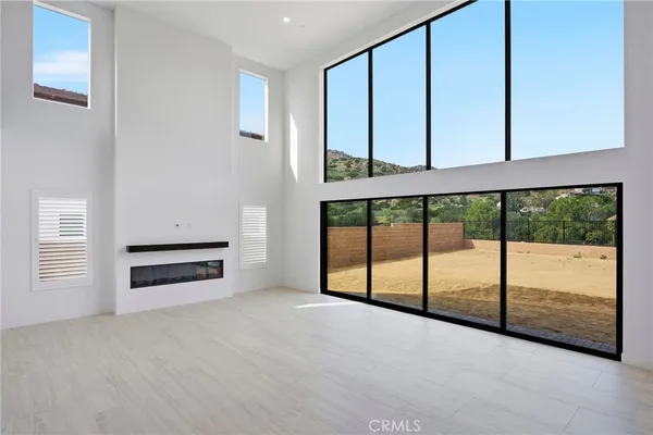 a view of staircase with lots of frames on wall and a window