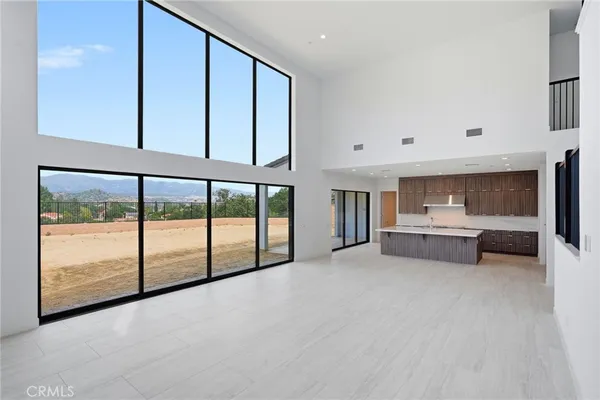 a kitchen with stainless steel appliances a large counter top a refrigerator and a sink
