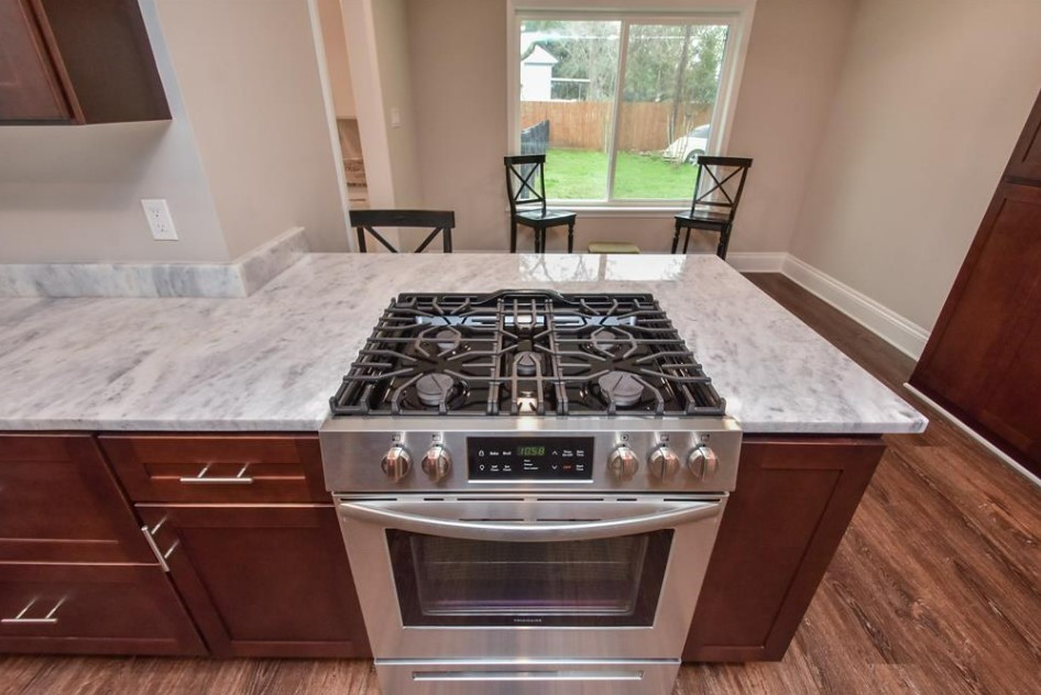 1506 10th Street Hempstead, TX 77445 - Photo 13 of 31 a stove top oven sitting inside of a kitchen