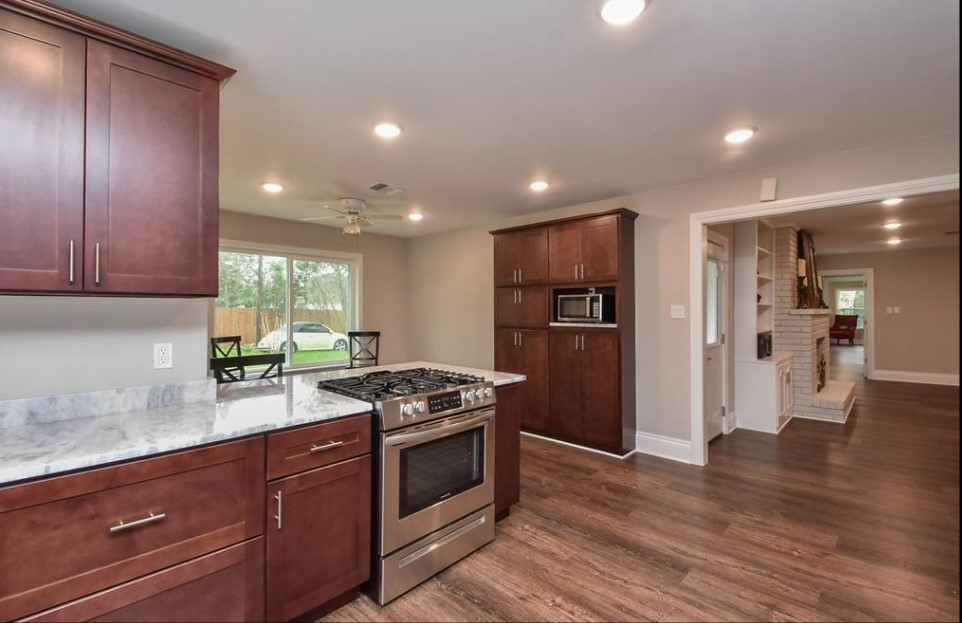 1506 10th Street Hempstead, TX 77445 - Photo 15 of 31 a kitchen with stainless steel appliances granite countertop a stove and a refrigerator