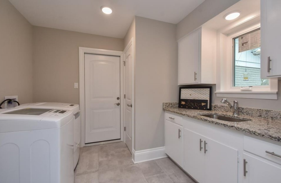 1506 10th Street Hempstead, TX 77445 - Photo 17 of 31 a kitchen with a stove sink and cabinets