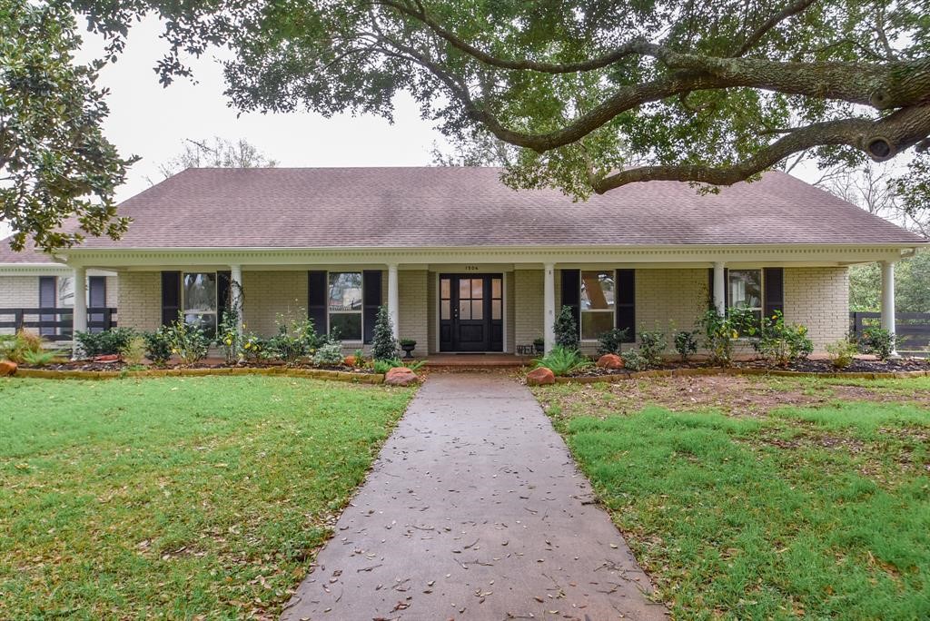 1506 10th Street Hempstead, TX 77445 - Photo 2 of 31 a front view of a house with yard patio and green space