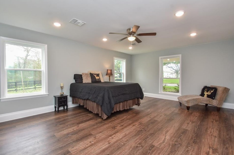 1506 10th Street Hempstead, TX 77445 - Photo 24 of 31 a bedroom with a bed and wooden floor
