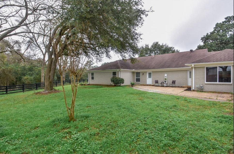 1506 10th Street Hempstead, TX 77445 - Photo 28 of 31 a view of a house with backyard and a tree