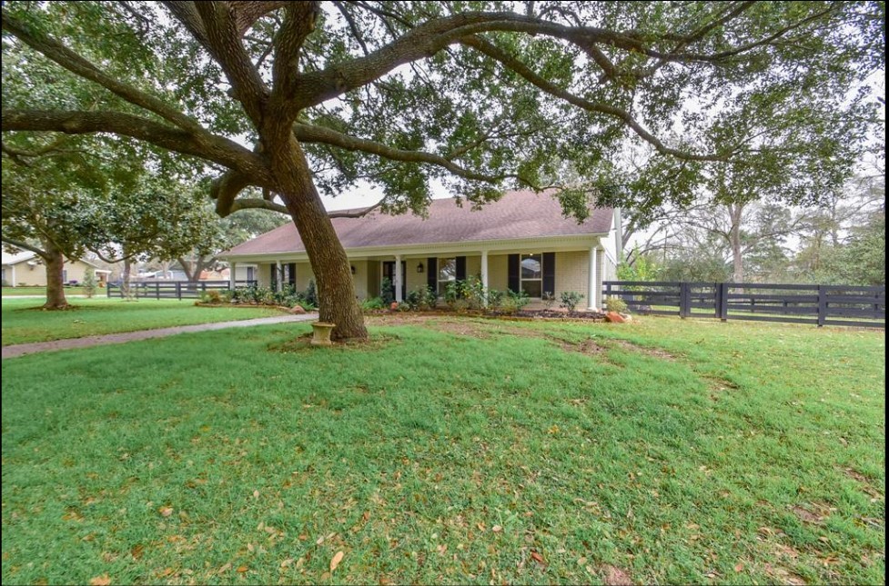 1506 10th Street Hempstead, TX 77445 - Photo 3 of 31 a front view of a house with a yard