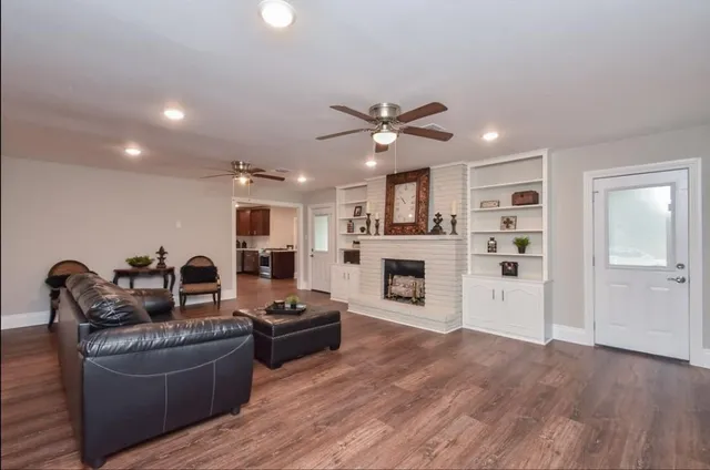 a living room with furniture fireplace and flat screen tv