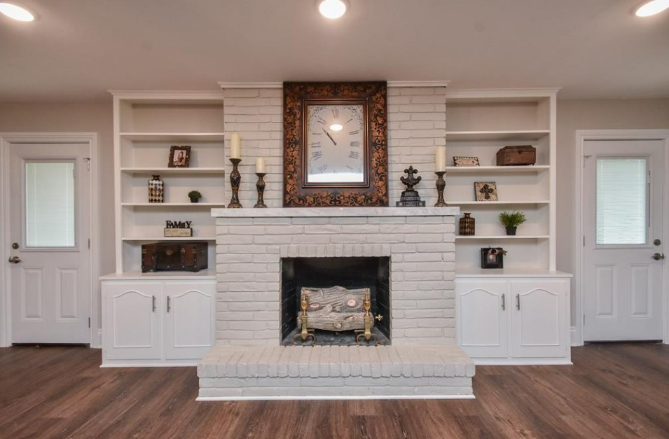 1506 10th Street Hempstead, TX 77445 - Photo 9 of 31 a living room with a fireplace and a flat screen tv