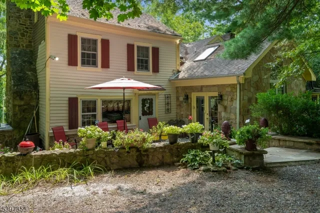 a front view of a house with plants