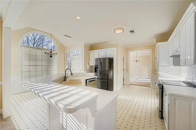 a bedroom with a bed and a refrigerator