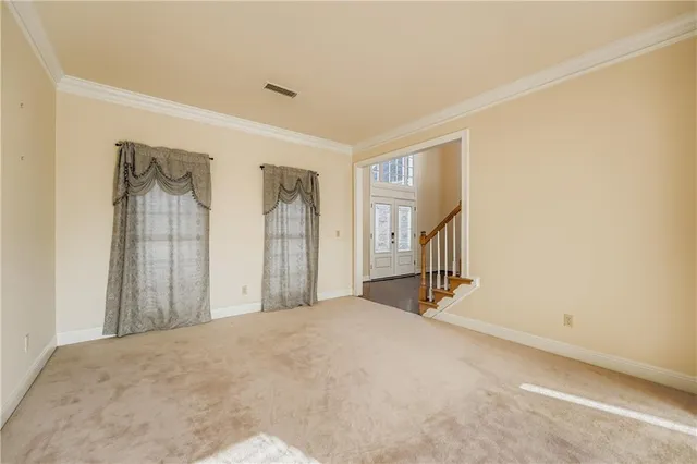a view of a hallway with wooden floor and a bathroom