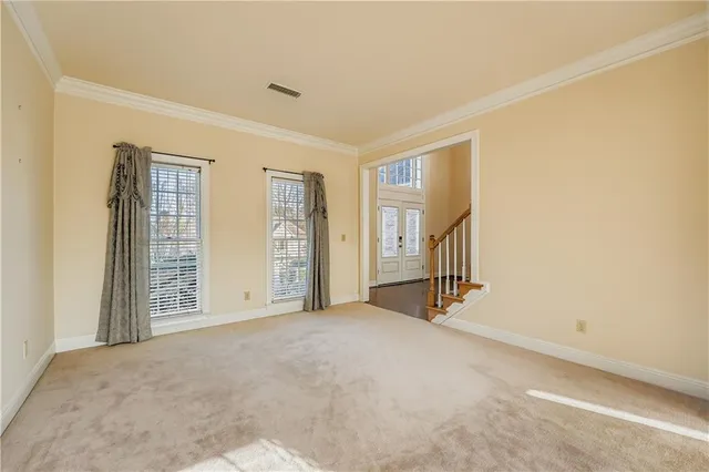 a view of an empty room with brick walls and stairs