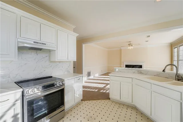 a kitchen with a sink stove and cabinets