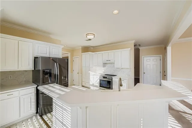 a kitchen with granite countertop a sink stove and refrigerator