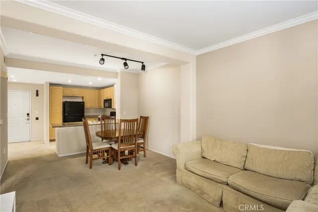 a living room with furniture and a dining table with wooden floor