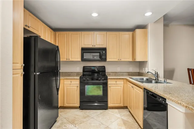 a kitchen with a sink stove and refrigerator