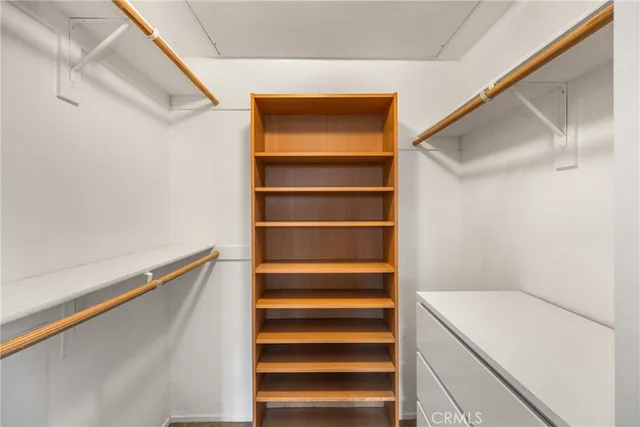 a view of walk in closet with empty racks
