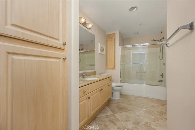 a bathroom with a double vanity sink toilet a mirror and shower