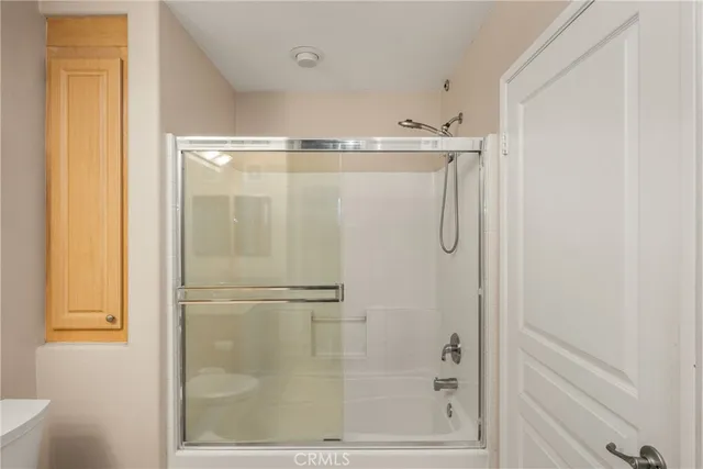 a bathroom with a glass shower door