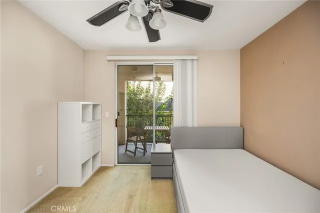 a bedroom with a bed and glass window