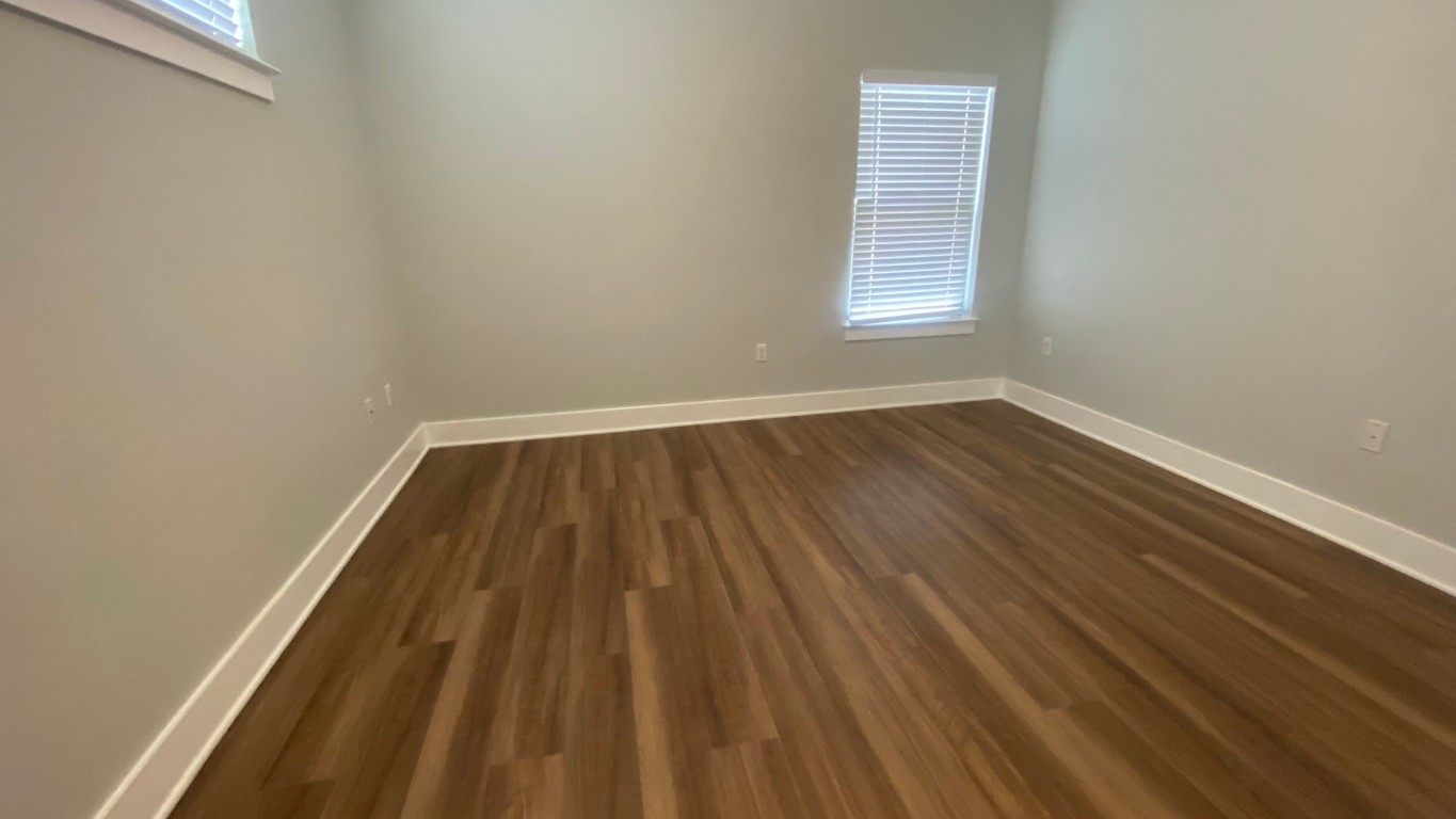13001 Hymeadow Drive, Unit 36 Austin, TX 78729 - Photo 11 of 20 an empty room with wooden floor and windows