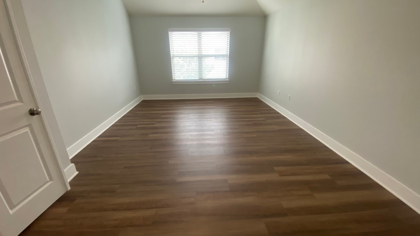 13001 Hymeadow Drive, Unit 36 Austin, TX 78729 - Photo 15 of 20 wooden floor in an empty room with a window