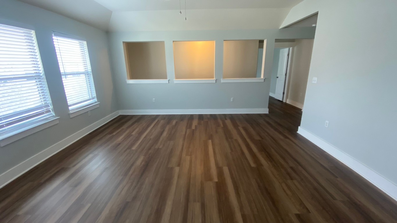 13001 Hymeadow Drive, Unit 36 Austin, TX 78729 - Photo 16 of 20 an empty room with wooden floor and windows