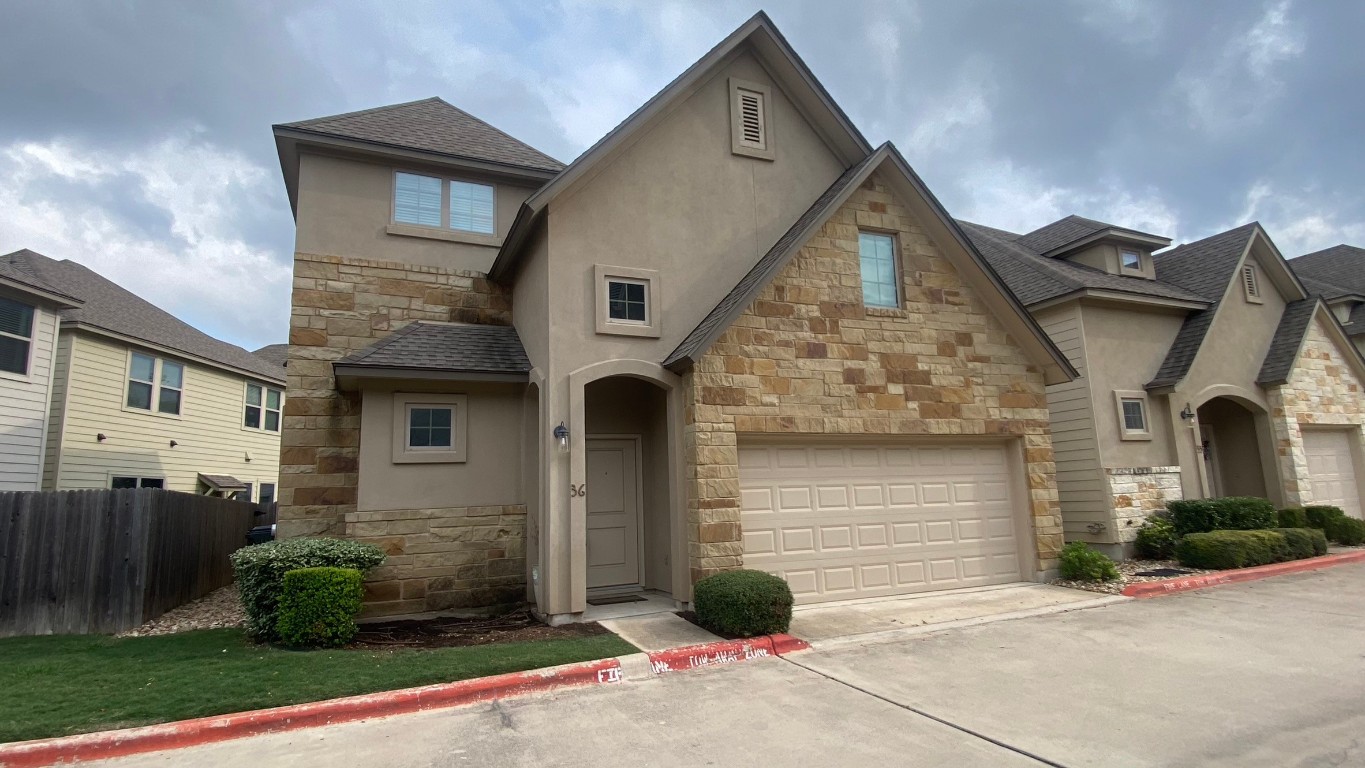 13001 Hymeadow Drive, Unit 36 Austin, TX 78729 - Photo 19 of 20 a front view of a house with garden