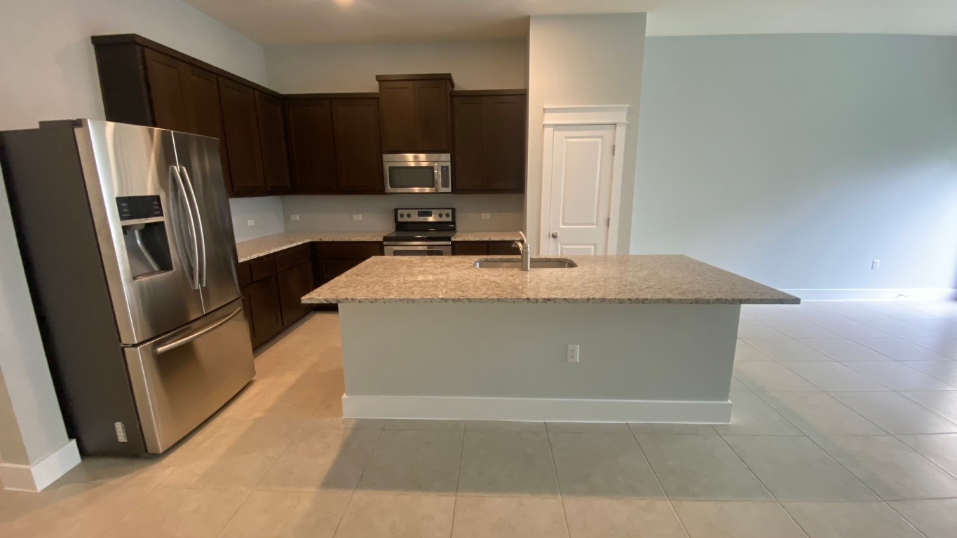 13001 Hymeadow Drive, Unit 36 Austin, TX 78729 - Photo 3 of 20 a kitchen with a refrigerator and a sink
