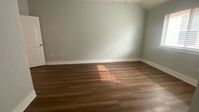 a view of room with window and hardwood floor