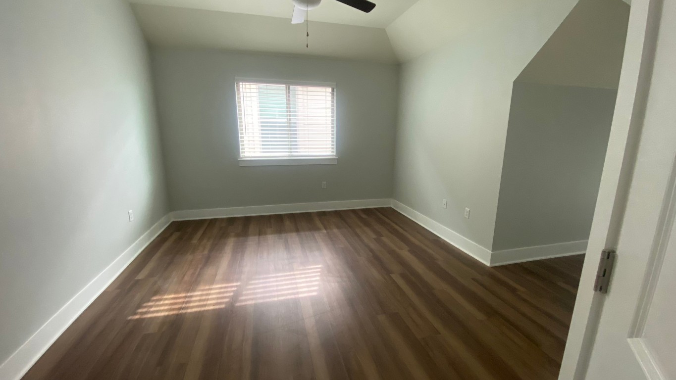 13001 Hymeadow Drive, Unit 36 Austin, TX 78729 - Photo 9 of 20 wooden floor in an empty room with a window