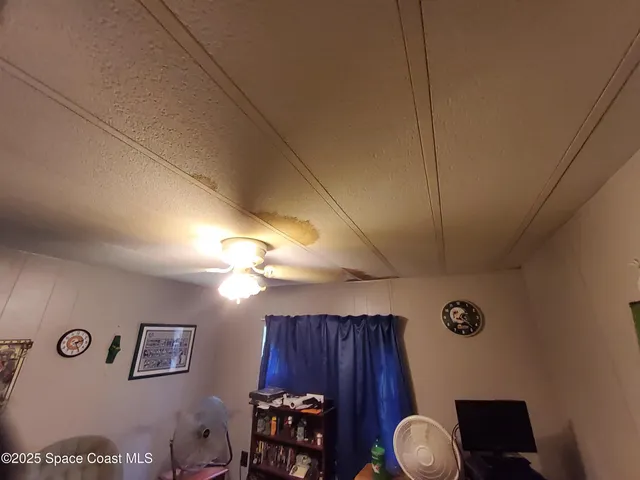 a view of a livingroom with furniture and a fan