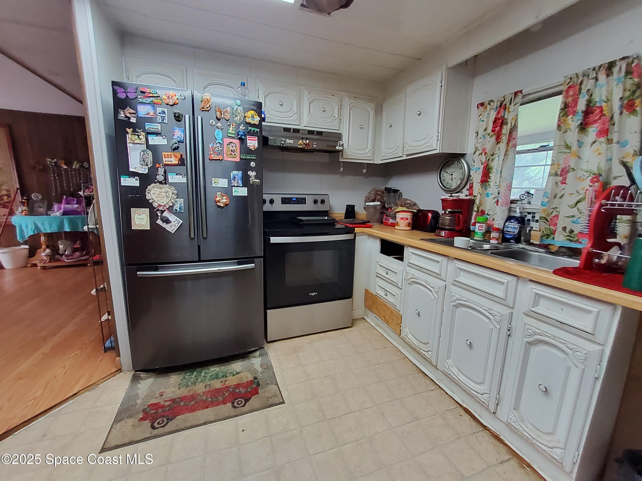 522 Clearview Drive Cocoa, FL 32927 - Photo 14 of 43 a kitchen with stainless steel appliances and cabinets