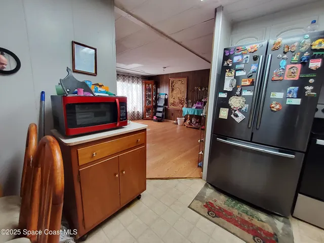 a kitchen with stainless steel appliances granite countertop a refrigerator and a stove