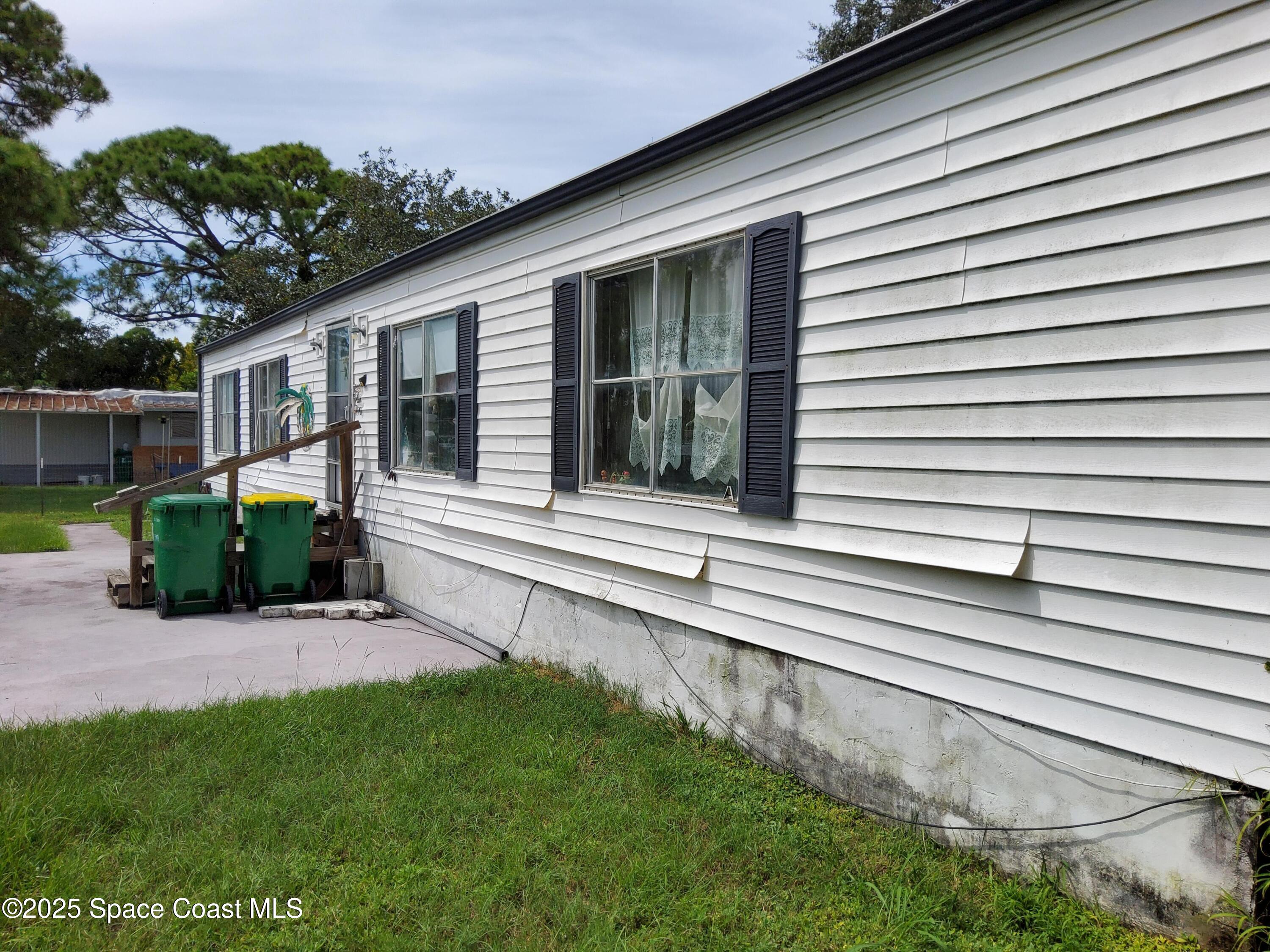 522 Clearview Drive Cocoa, FL 32927 - Photo 23 of 43 a view of a house with a small yard and a large window