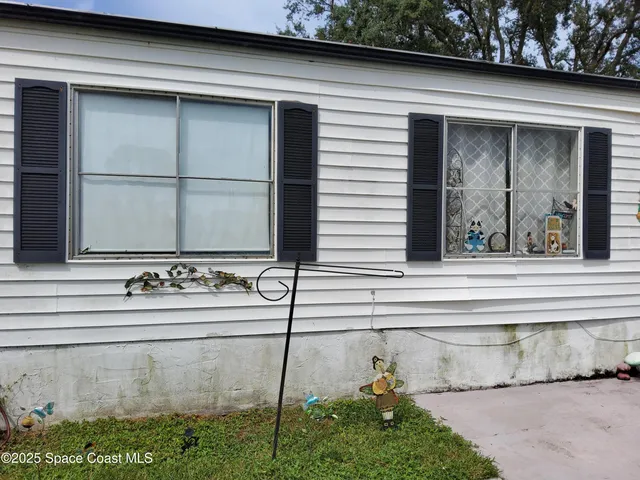 a backyard of a house with yard and outdoor seating