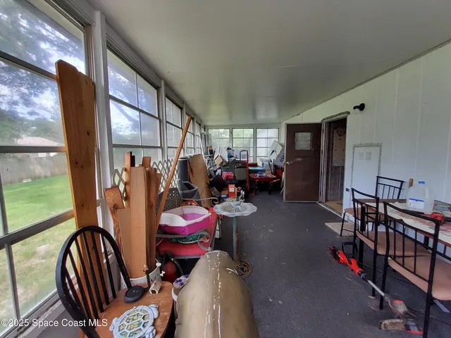 a living room with furniture a rug toys and a window