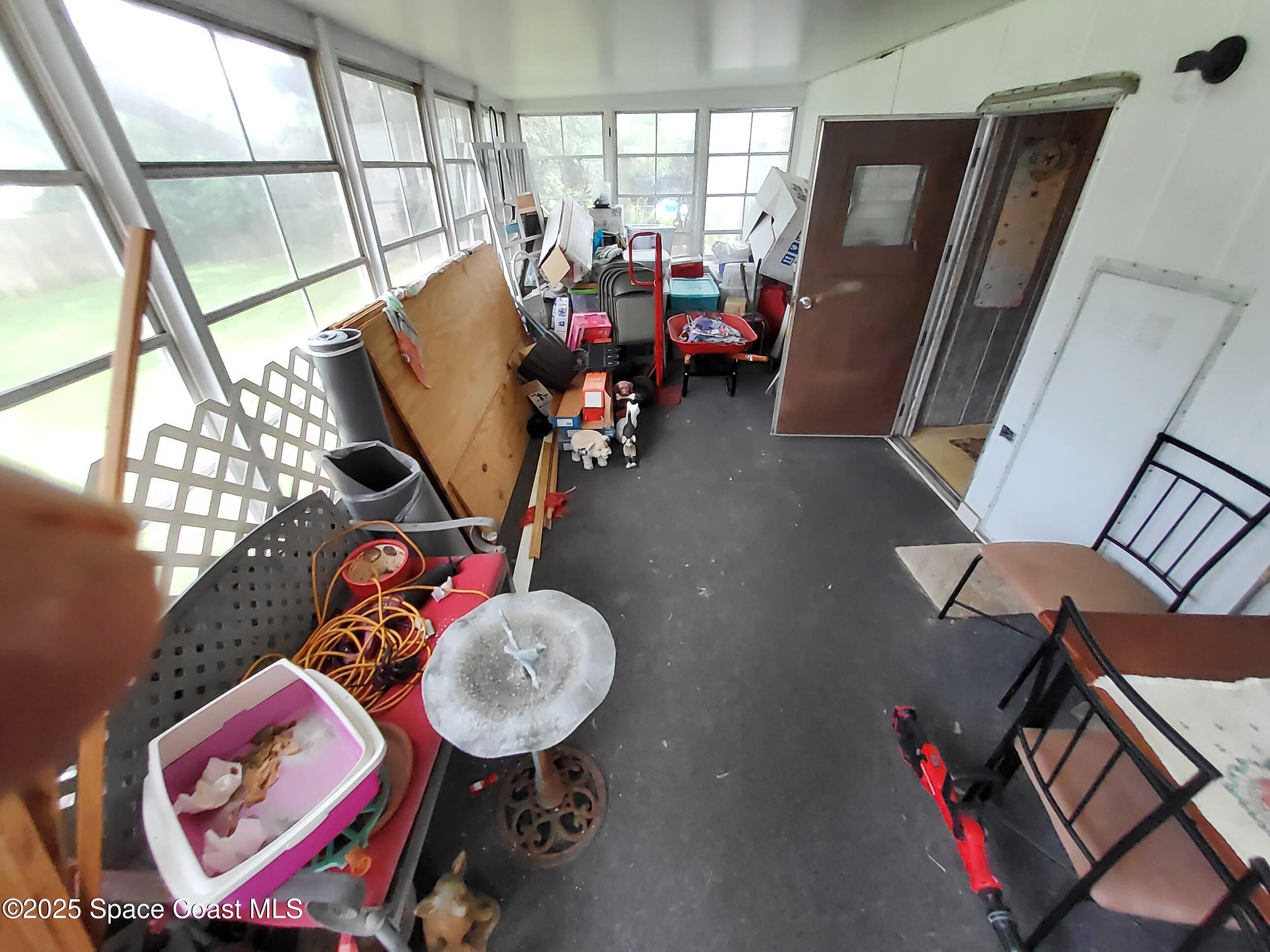 522 Clearview Drive Cocoa, FL 32927 - Photo 31 of 43 a living room with furniture a rug toys and a window