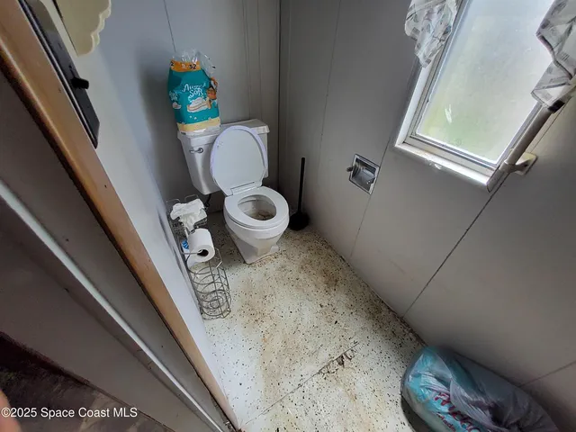 a bed room with a bed and a chair