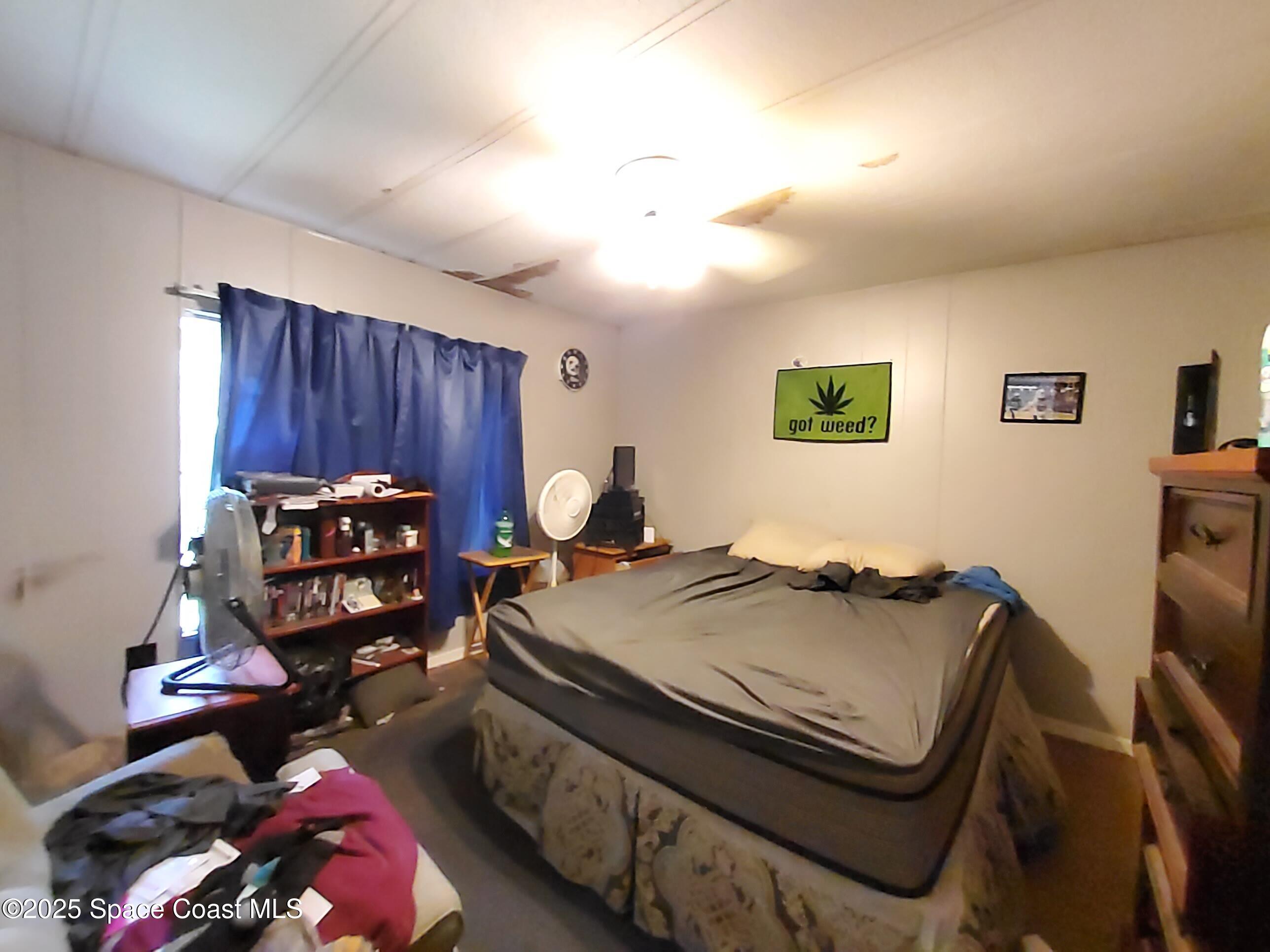 522 Clearview Drive Cocoa, FL 32927 - Photo 43 of 43 a bed room with a bed and a chair