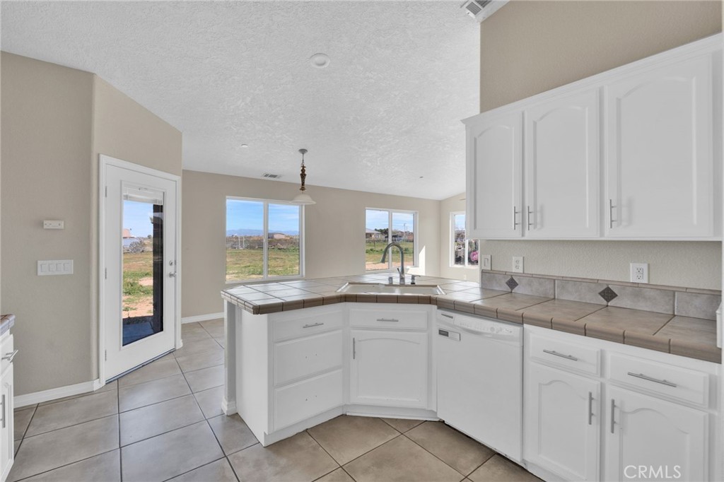 12865 Barbet Road Phelan, CA 92371 - Photo 12 of 51 a kitchen with a sink and cabinets