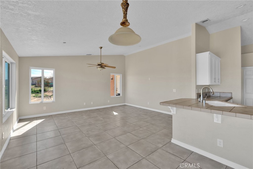 12865 Barbet Road Phelan, CA 92371 - Photo 14 of 51 a view of a kitchen with a sink and chandelier