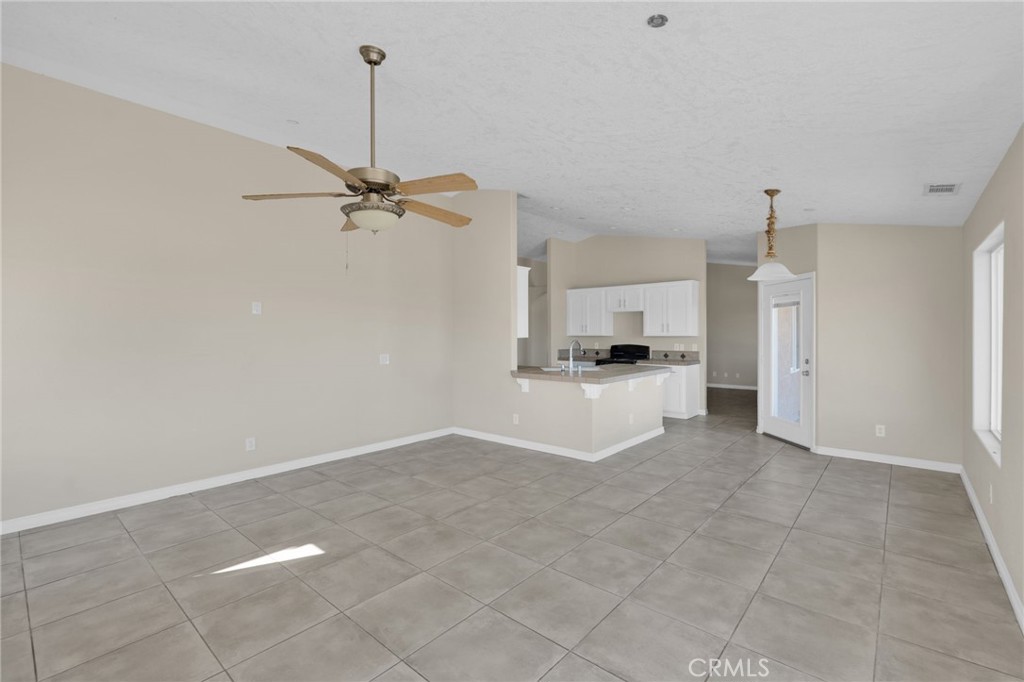 12865 Barbet Road Phelan, CA 92371 - Photo 15 of 51 a view of a kitchen with a sink and a ceiling fan
