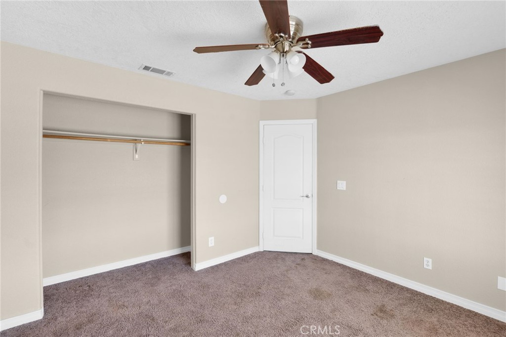 12865 Barbet Road Phelan, CA 92371 - Photo 21 of 51 an empty room with chandelier fan
