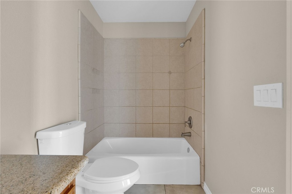 12865 Barbet Road Phelan, CA 92371 - Photo 24 of 51 a bath room with a toilet and a bath tub