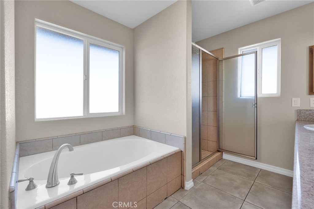 12865 Barbet Road Phelan, CA 92371 - Photo 27 of 51 a bathroom with a bathtub and a shower