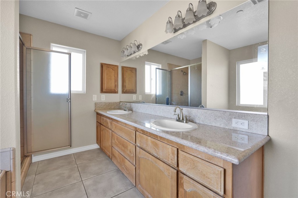 12865 Barbet Road Phelan, CA 92371 - Photo 28 of 51 a bathroom with a granite countertop sink and a mirror