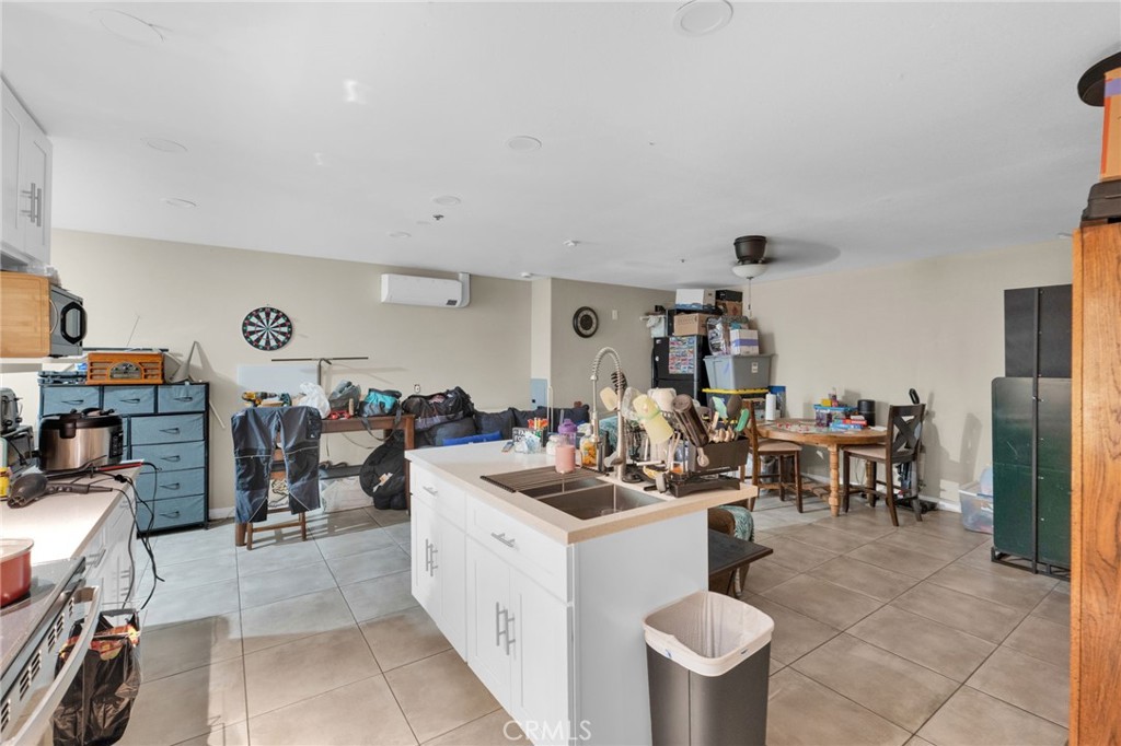 12865 Barbet Road Phelan, CA 92371 - Photo 35 of 51 a room with gym equipment and a view of living room